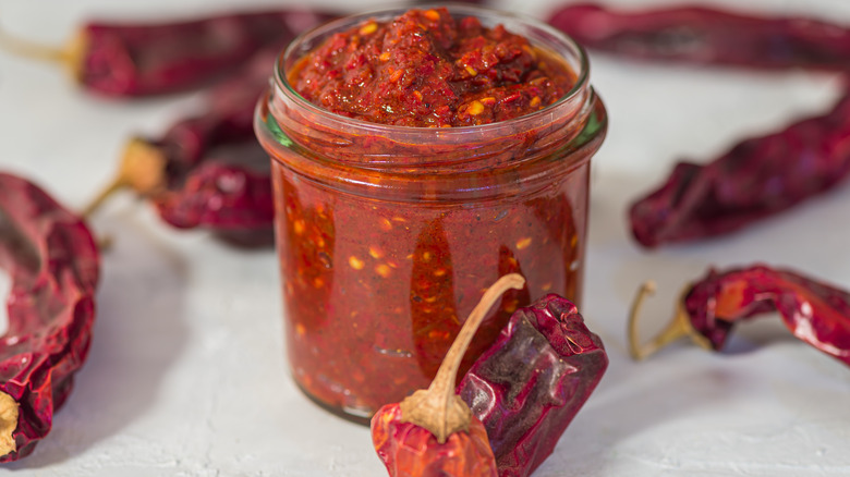 Harissa in jar with peppers