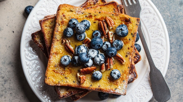 Top-down view of French toast topped with blueberries and pecans 