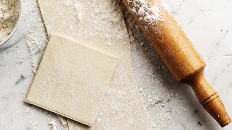 Puff pastry sheets and rolling pin 