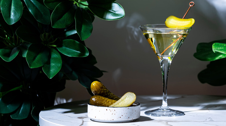 A martini with a pickle garnish