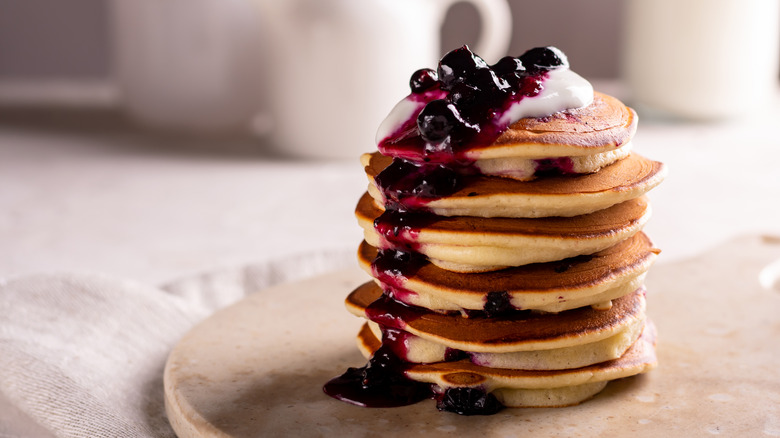 Stack of pancakes with blueberry syrup