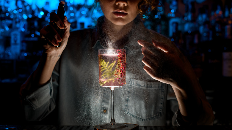 Bartender spraying drink