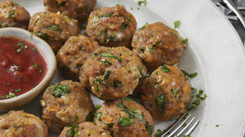 Turkey meatballs surrounding red sauce