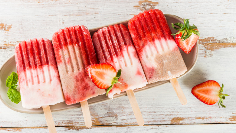 strawberry and cream popsicles on  wood table