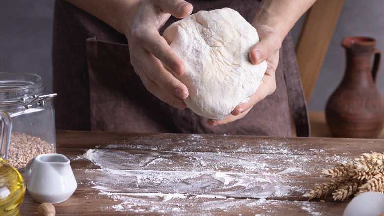 hands holding dough