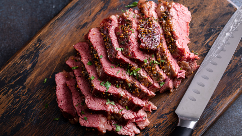 Sliced corned beef on cutting board