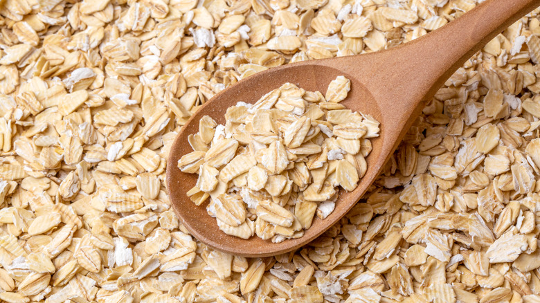 Spoon on pile of rolled oats 