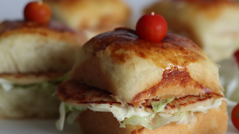 pizza slider topped with a cherry tomato