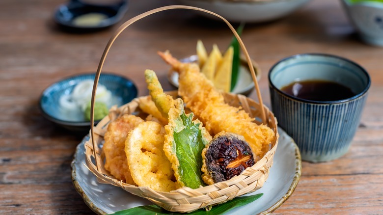 basket of vegetable tempura with sauces, pottery