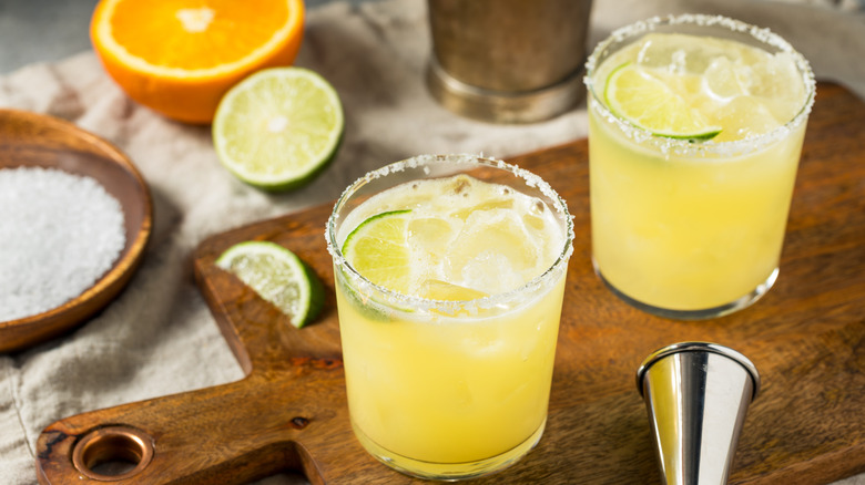 Orange margaritas on cutting board