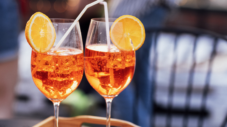 two glasses of aperol spritz garnished with orange slices