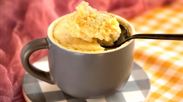 Fluffy white mug cake with spoon