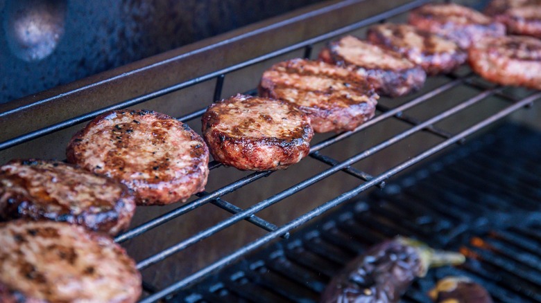 Beef burgers on warming rack