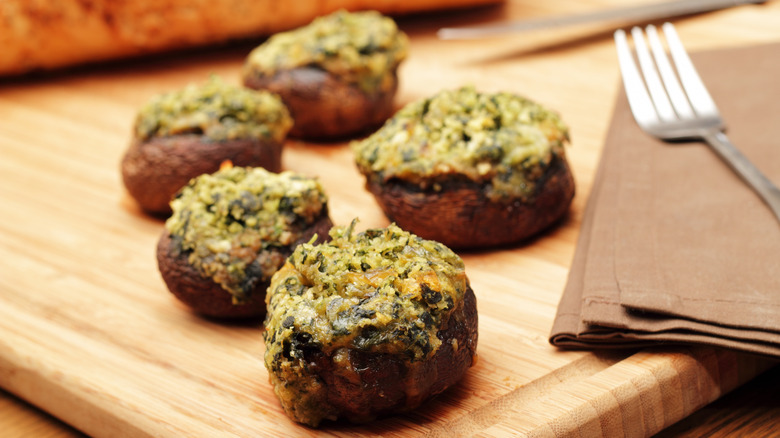 stuffed mushrooms on cutting board