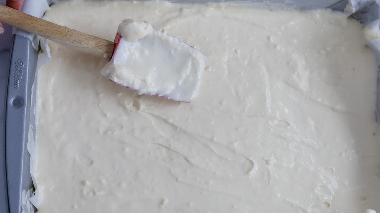 white batter in pan with rubber spatula