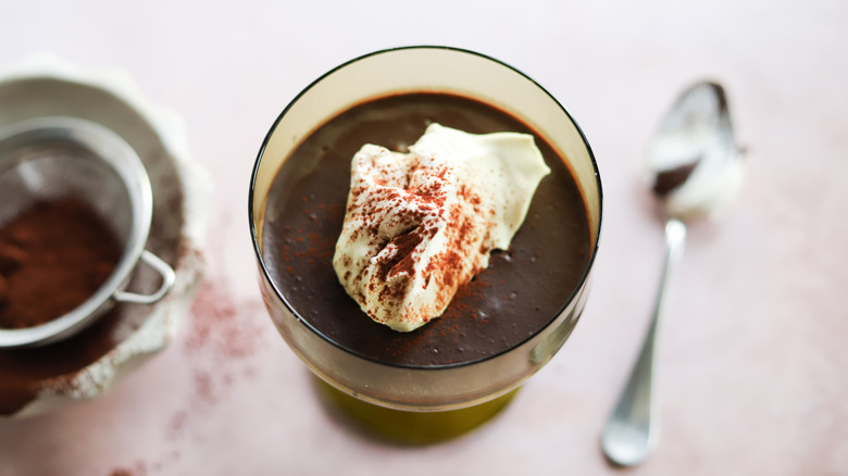 Cup of dark chocolate pudding with whipped cream