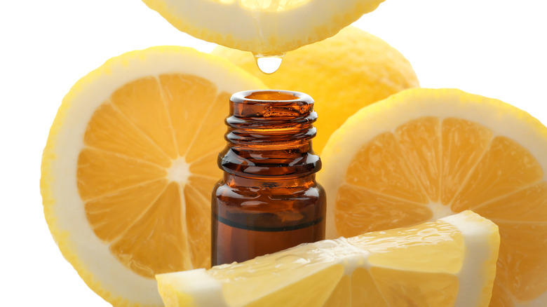 lemon juice dripping into glass bottle