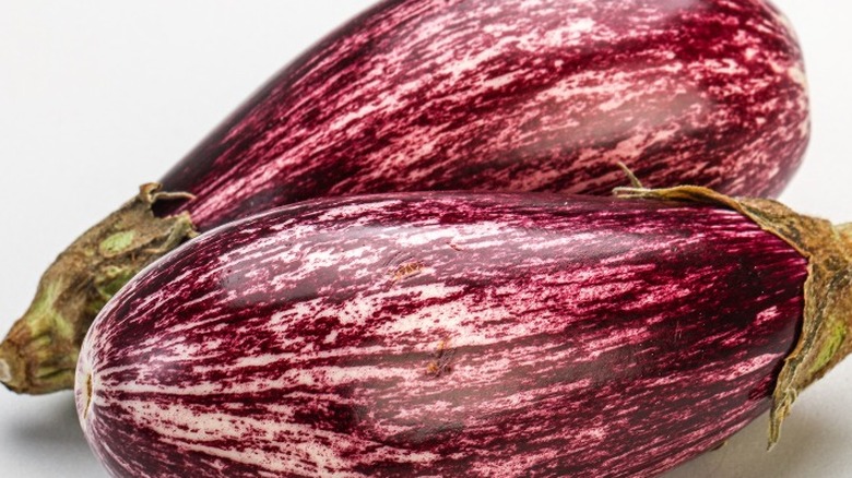 Two mottled graffiti eggplants