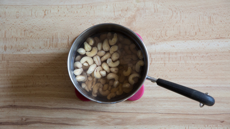 cashews soaking in small saucepan