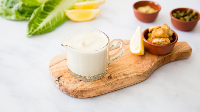 Caesar dressing served on table