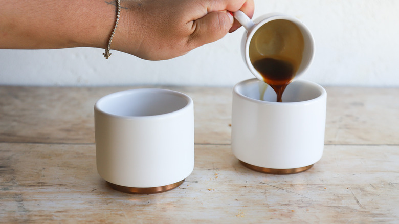 Pouring espresso into mugs