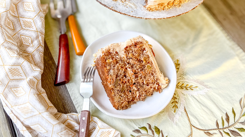 Slice of vegan carrot cake with cinnamon-cashew frosting