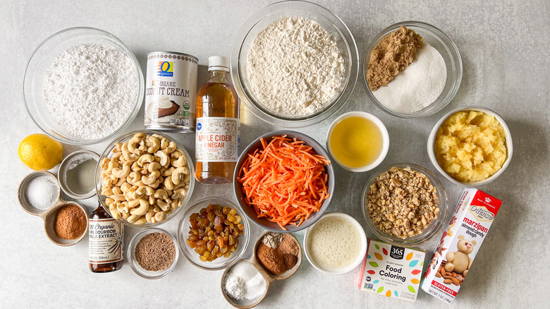 Vegan carrot cake with cinnamon-cashew frosting ingredients on counter top