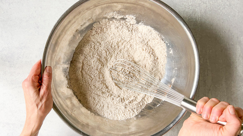 Whisking together dry ingredients for vegan carrot cake