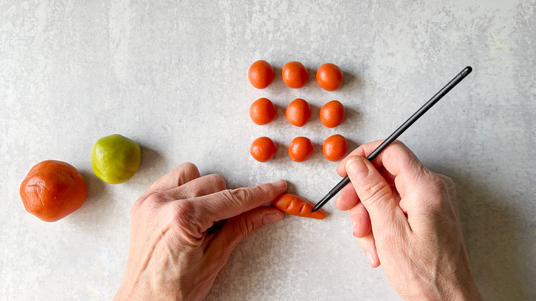 Making ridges in marzipan carrots with a pick