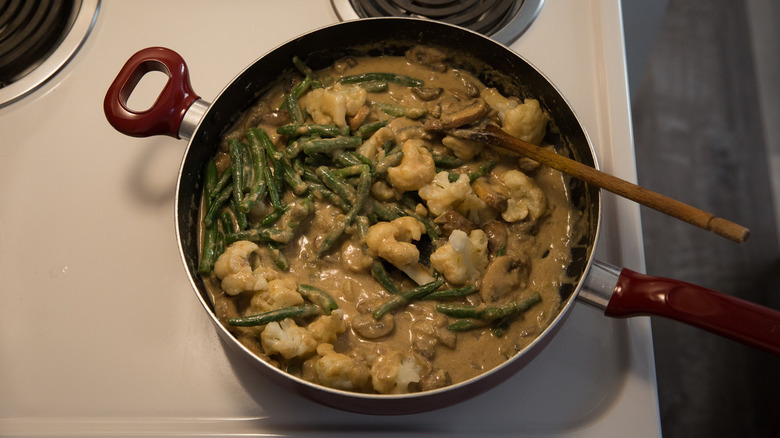 stirring green bean casserole sauce 