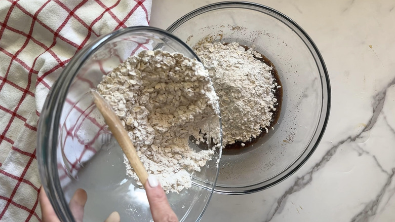 hand adding dry ingredients