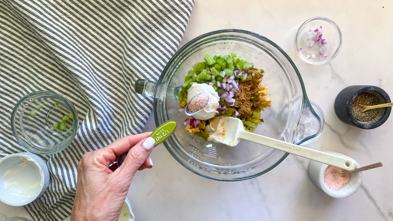 adding ingredients to glass bowl