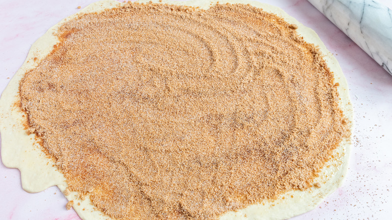 filling cinnamon roll dough