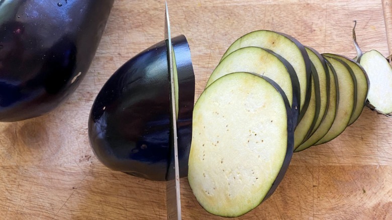 knife cutting into eggplant