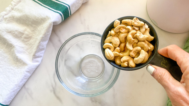cup of cashews over bowl