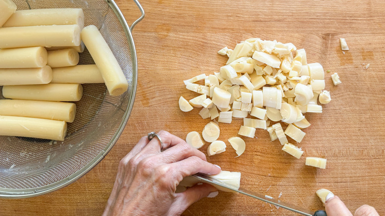 hand cutting hearts of palm