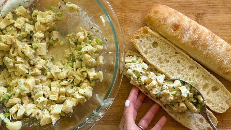 hand adding mixture to roll