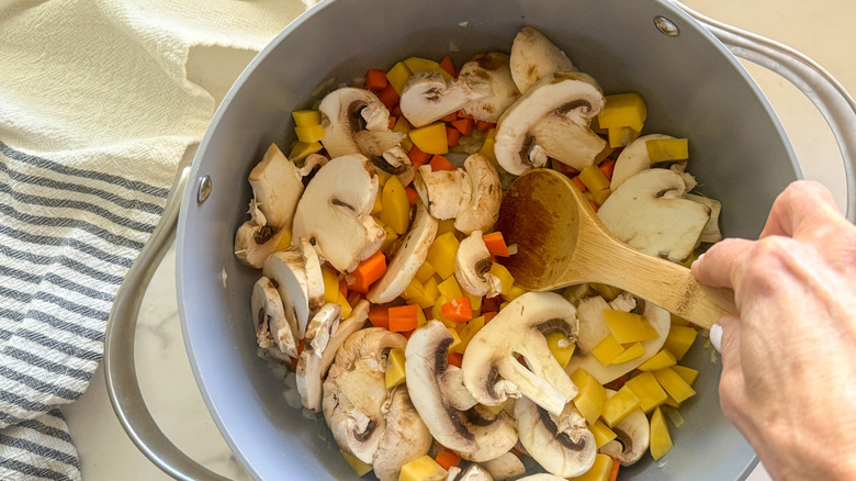 hand stirring vegetables