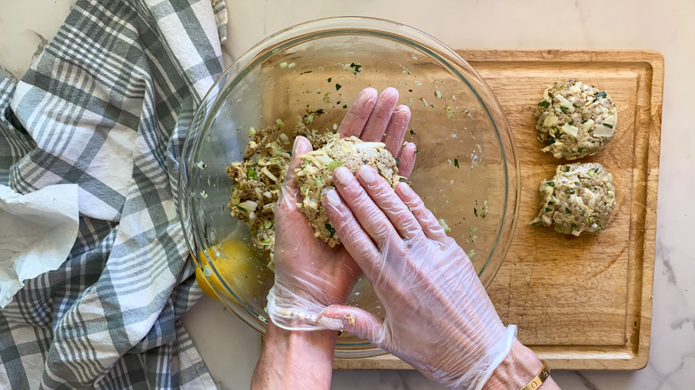 hands pressing mixture into patties