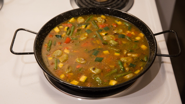 broth cooking in paella pan 