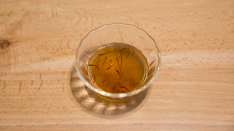 saffron threads soaking in broth 