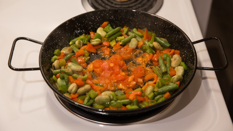 vegetable paella cooking on stove