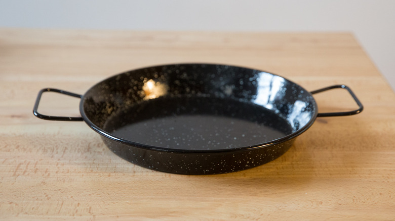 black paella pan on table