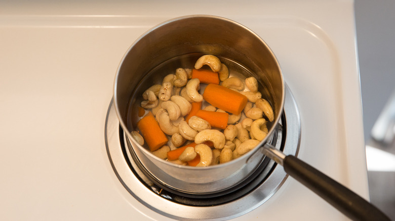 cashews and carrot in saucepan 