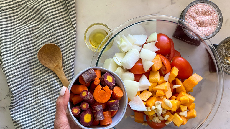 adding carrots to bowl of other ingredients