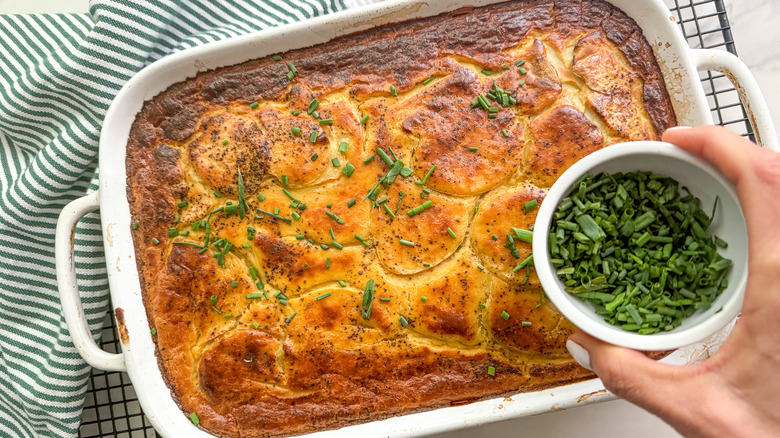 adding chives to potatoes