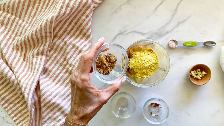 adding spices to blender