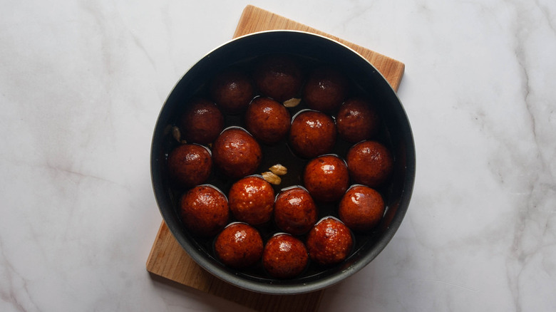 Fried sweet potato Gulab Jamun balls in a pot