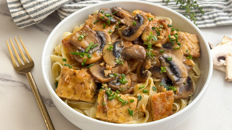 Bowl of tempeh Marsala with gold fork