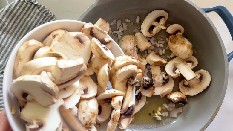 Adding mushrooms to a pot